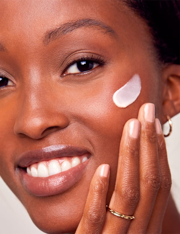 A woman applying a NIVEA cream