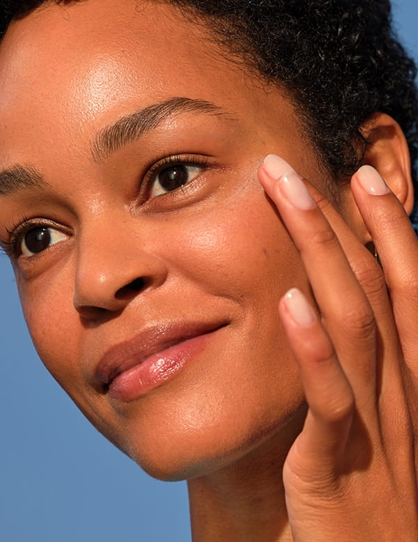 A woman touching her cheek